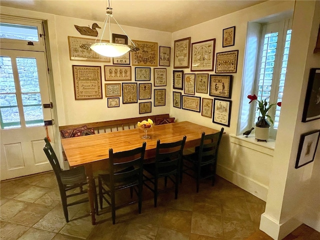 dining space with plenty of natural light and tile floors