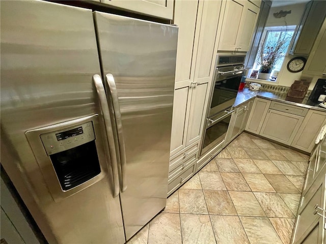 kitchen with light tile floors and appliances with stainless steel finishes