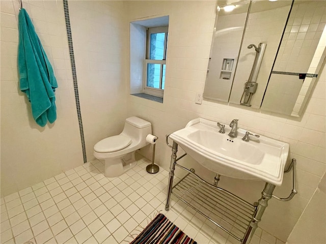 bathroom with tile walls, tile floors, sink, and toilet