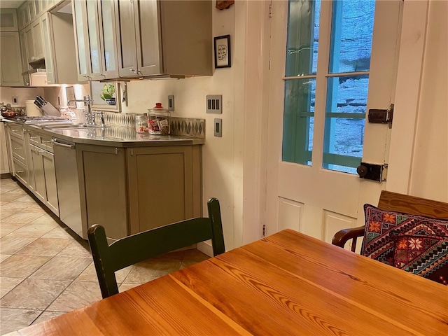 kitchen featuring stainless steel dishwasher, stainless steel counters, light tile flooring, gray cabinets, and sink