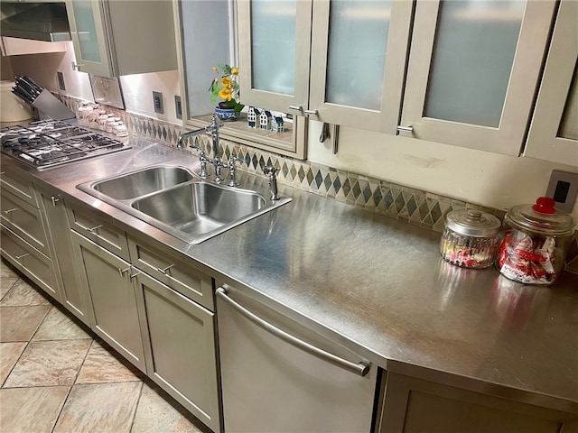 kitchen featuring stainless steel appliances, sink, and light tile floors