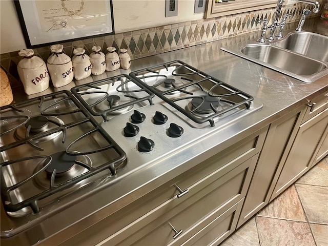 room details featuring stainless steel counters, sink, light tile floors, and range