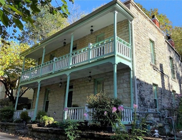 view of side of home with covered porch