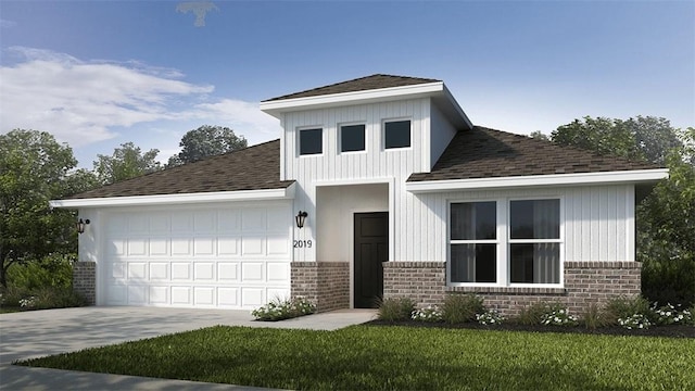 view of front of home featuring a garage and a front lawn