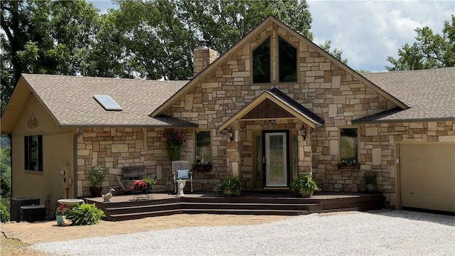 view of front of house featuring a garage and central AC unit