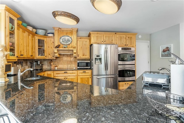20462 Tacker Rd, Garfield, AR 72732 - kitchen with stainless steel appliances, tasteful backsplash, glass insert cabinets, and dark stone counters