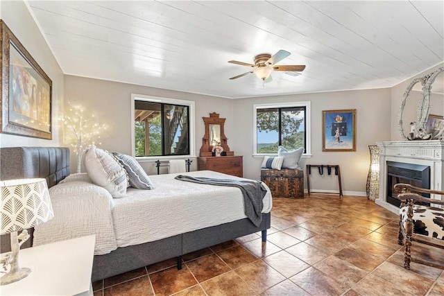20462 Tacker Rd, Garfield, AR 72732 - bedroom with multiple windows, a glass covered fireplace, and ceiling fan