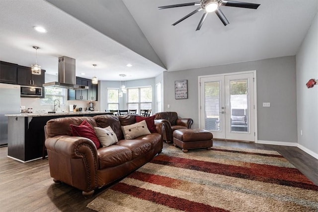 living room featuring ceiling fan, dark wood-type flooring, french doors, and vaulted ceiling