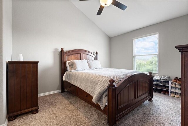 bedroom with ceiling fan, light carpet, and vaulted ceiling