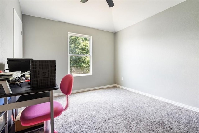 carpeted office space featuring ceiling fan and vaulted ceiling