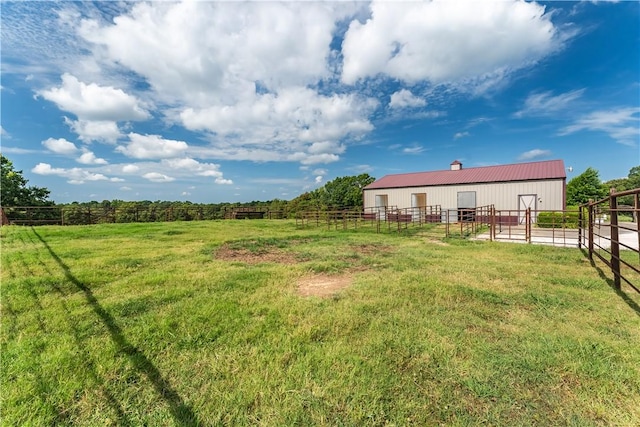 view of yard with a rural view and an outdoor structure