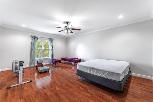 bedroom featuring dark hardwood / wood-style flooring, ceiling fan, and ornamental molding