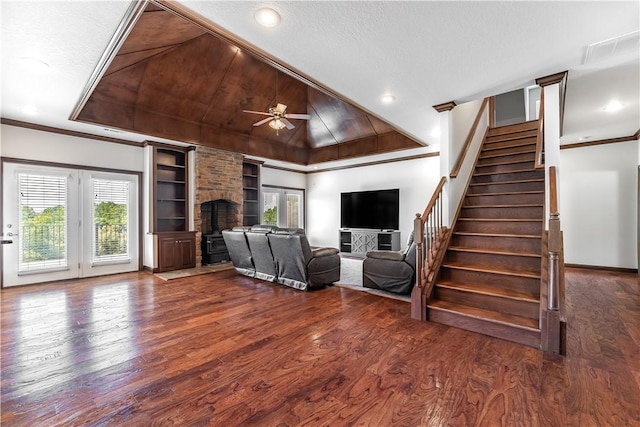 unfurnished living room featuring a fireplace, crown molding, ceiling fan, and dark wood-type flooring