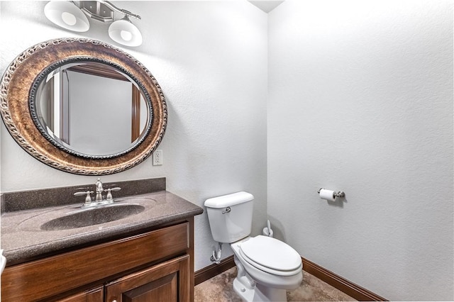 bathroom featuring tile patterned floors, vanity, and toilet