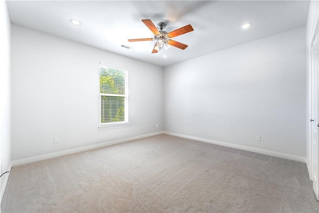 unfurnished room featuring ceiling fan and light colored carpet