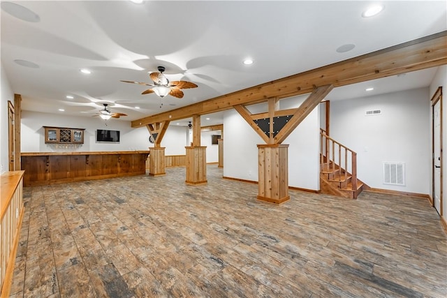 unfurnished living room featuring hardwood / wood-style flooring and ceiling fan