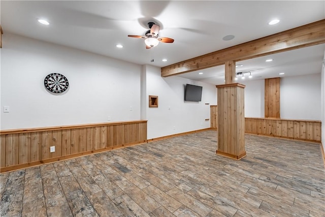 interior space with beam ceiling, ceiling fan, and hardwood / wood-style flooring