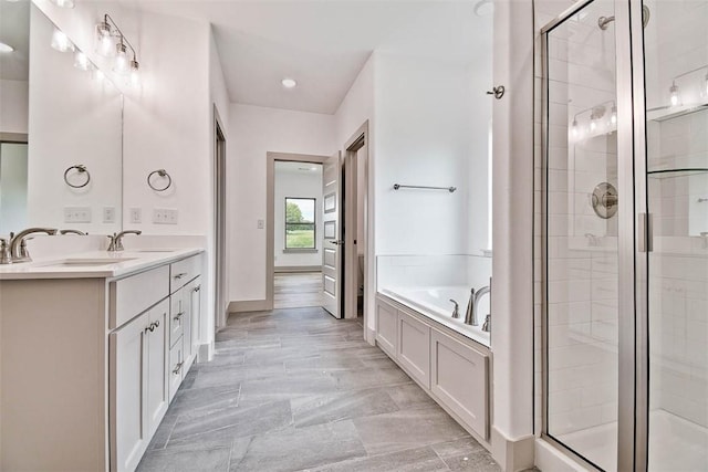 bathroom featuring vanity and shower with separate bathtub