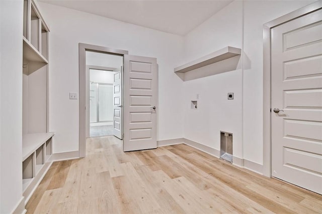 washroom featuring electric dryer hookup, hookup for a washing machine, and light hardwood / wood-style flooring