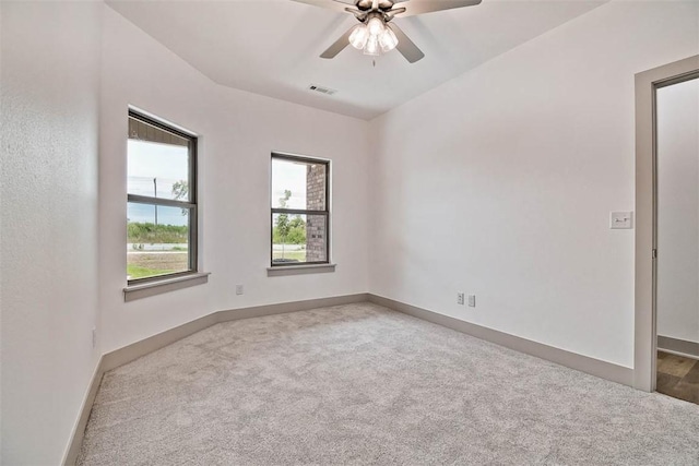 carpeted spare room with ceiling fan