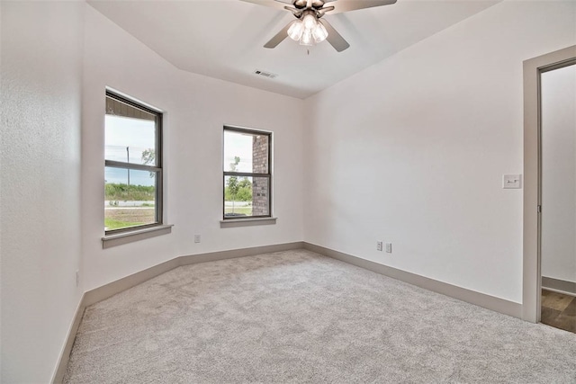 carpeted spare room featuring ceiling fan