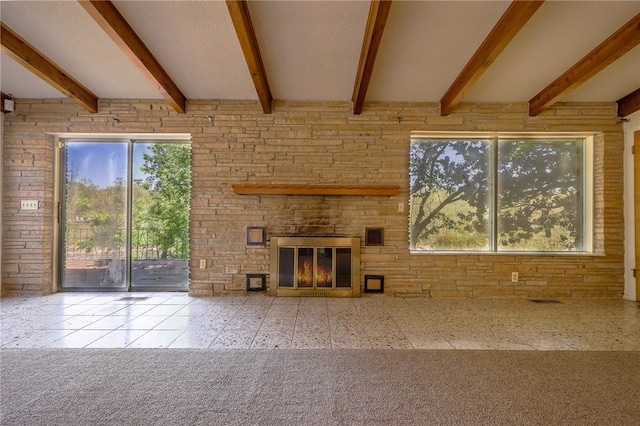 unfurnished living room with beam ceiling and a fireplace