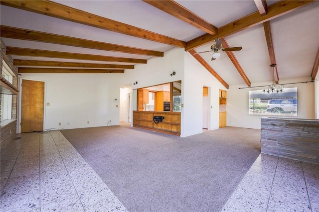 unfurnished living room with ceiling fan with notable chandelier, carpet, and vaulted ceiling with beams