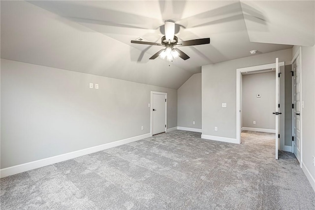 additional living space with lofted ceiling, baseboards, a ceiling fan, and carpet flooring