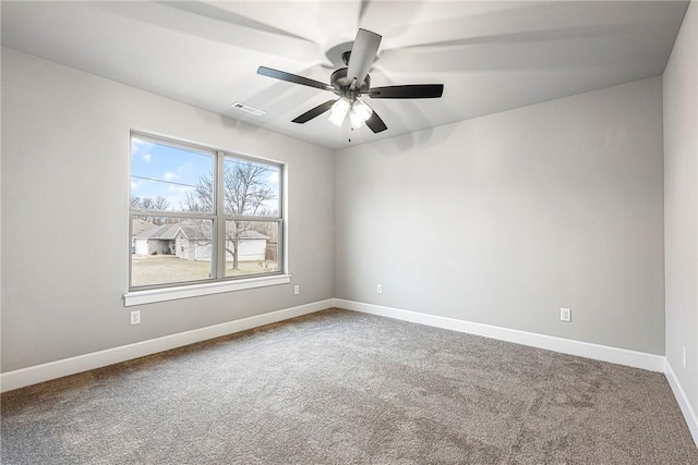 unfurnished room featuring a ceiling fan, carpet, visible vents, and baseboards