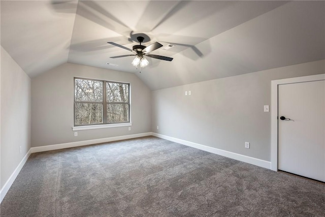 additional living space featuring lofted ceiling, carpet floors, a ceiling fan, and baseboards