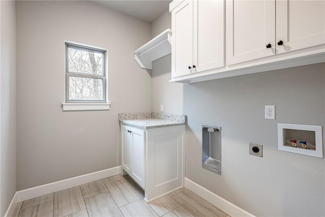 laundry room featuring baseboards, hookup for a washing machine, cabinet space, and hookup for an electric dryer