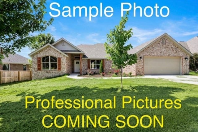 view of front of property with a front lawn and a garage