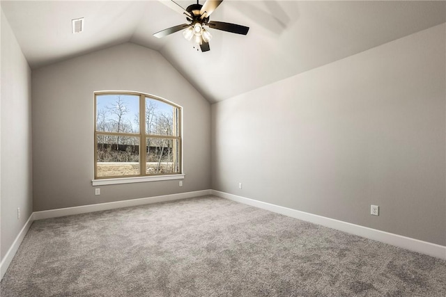 unfurnished room featuring carpet floors, lofted ceiling, visible vents, ceiling fan, and baseboards