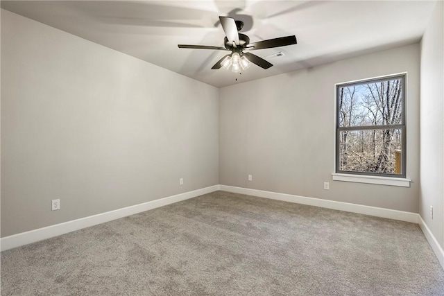 spare room featuring carpet flooring, ceiling fan, and baseboards