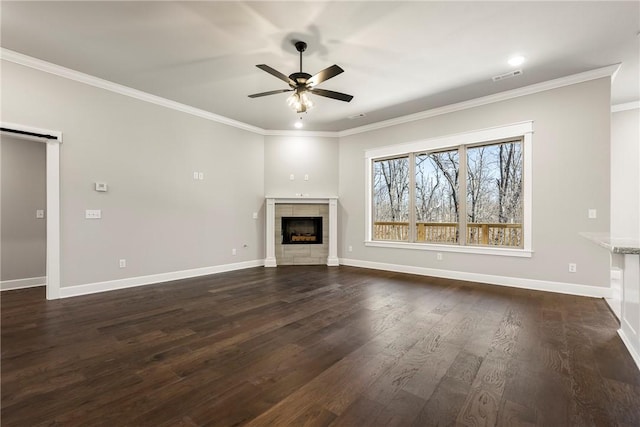 unfurnished living room featuring ceiling fan, dark wood-style flooring, crown molding, and a barn door