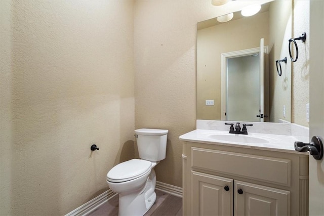 bathroom with hardwood / wood-style floors, vanity, and toilet