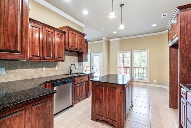 kitchen with ornamental molding, sink, dark stone countertops, dishwasher, and a center island