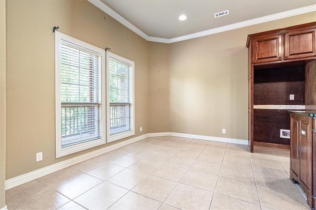 interior space with light tile patterned flooring and ornamental molding