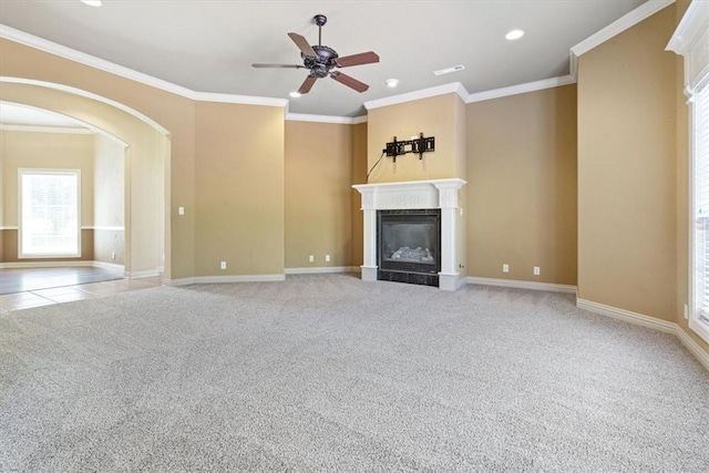 unfurnished living room with light carpet, ceiling fan, and crown molding