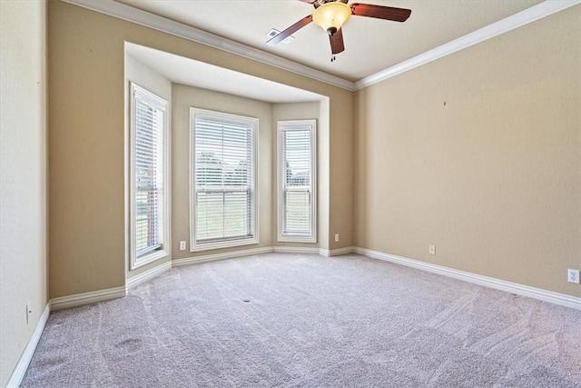 carpeted empty room featuring crown molding and ceiling fan