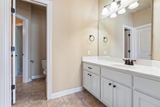 bathroom with tile patterned floors, vanity, and toilet