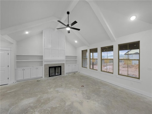 unfurnished living room featuring built in shelves, ceiling fan, a tiled fireplace, and vaulted ceiling with beams