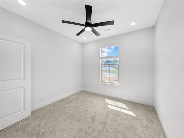 carpeted spare room featuring recessed lighting, ceiling fan, baseboards, and visible vents