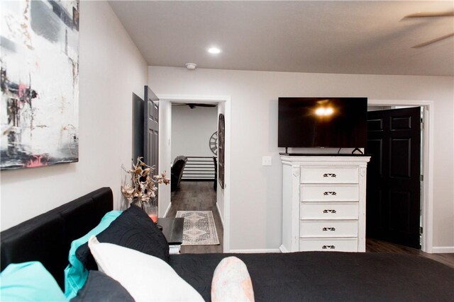 living room with ceiling fan and dark wood-type flooring