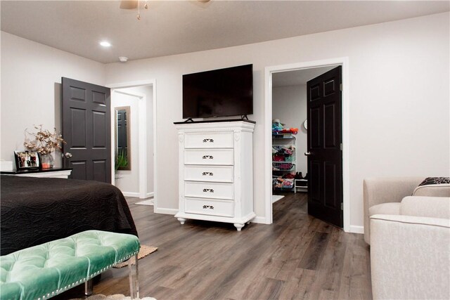 bedroom with dark hardwood / wood-style flooring and ceiling fan