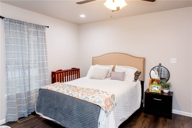 bedroom with ceiling fan and dark hardwood / wood-style flooring