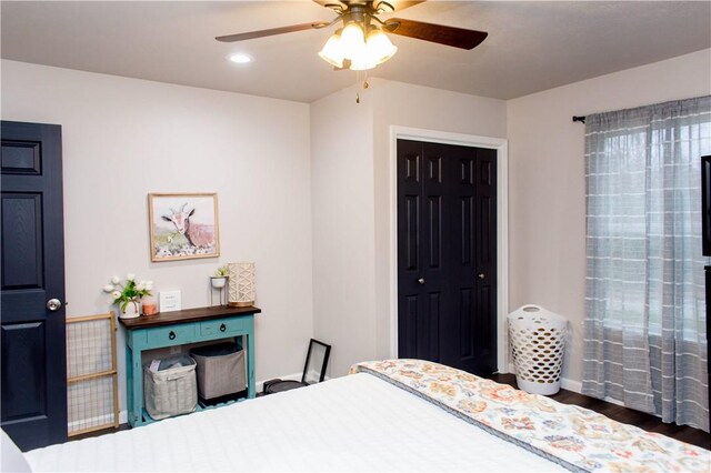 bedroom with dark hardwood / wood-style flooring, a closet, and ceiling fan