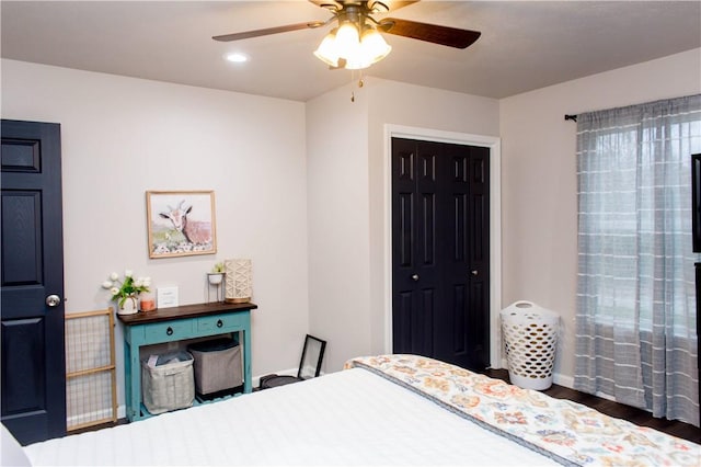 bedroom with a closet, wood finished floors, a ceiling fan, and recessed lighting