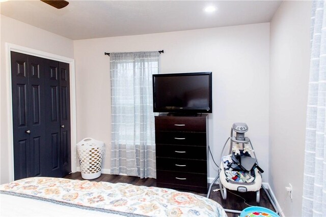 bedroom with a closet, ceiling fan, and dark hardwood / wood-style floors