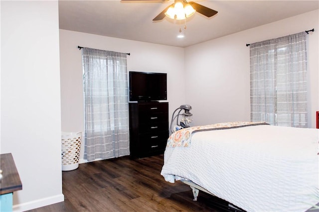 bedroom featuring ceiling fan, baseboards, and wood finished floors